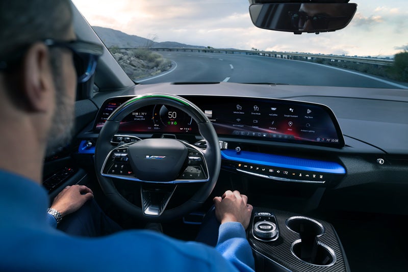 Front View of the 2026 OPTIQ-V Driving Through the Dusk Utilizing its Headlights | Cadillac of South San Francisco in Colma CA